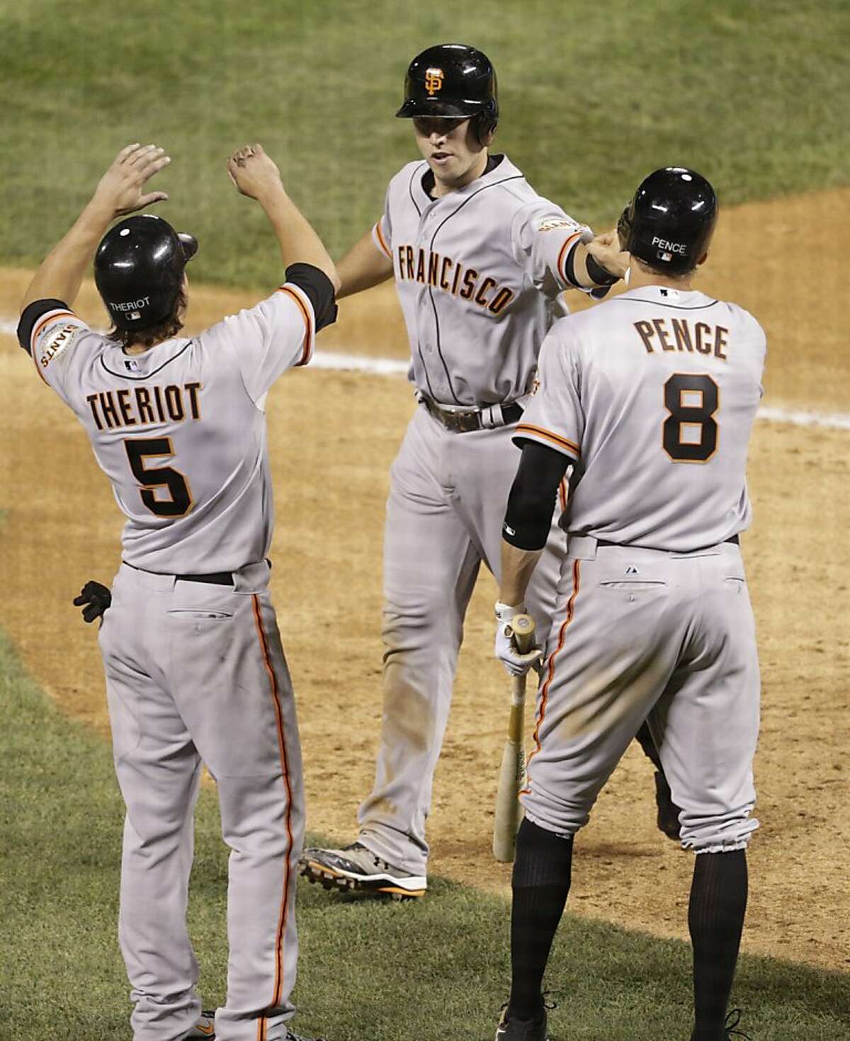 Colorado Rockies' Todd Helton (17) is congratulated by teammate