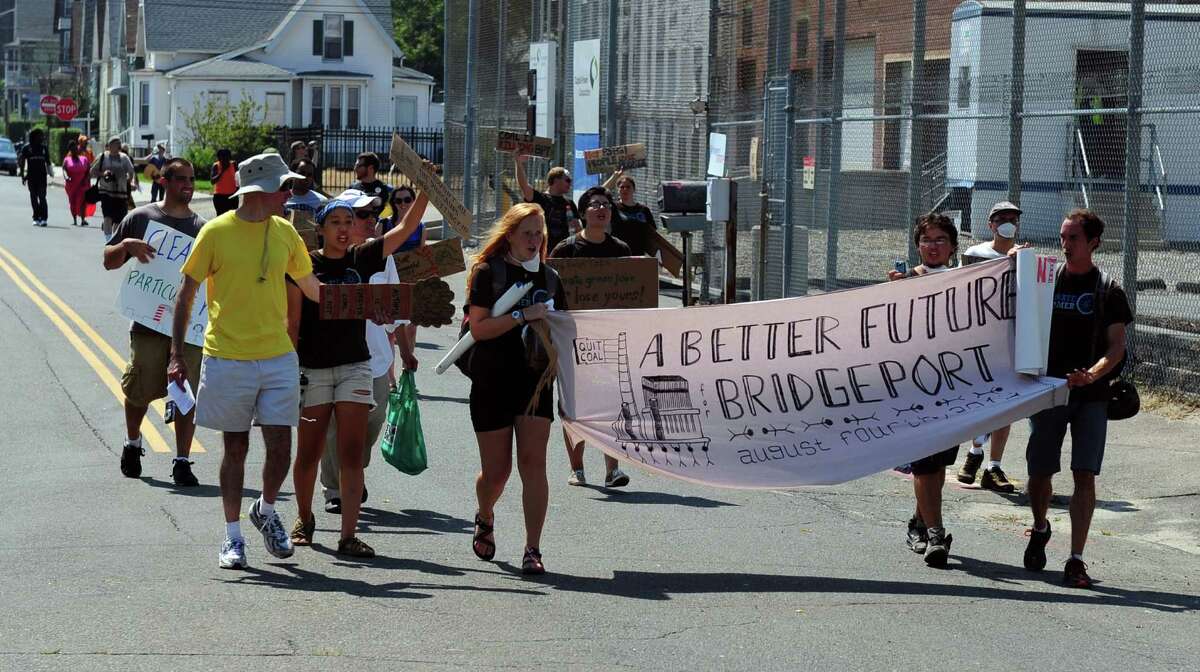 Protesters hold a rally outside the gate of the PSEG coal plant on Atlantic Street in Bridgeport Saturday, August 4, 2012. The group marched from City Lights Art Gallery to the Bridgeport Harbor Power Station where they demonstrated against the use of fossil fuels and in favor of clean energy and green jobs.