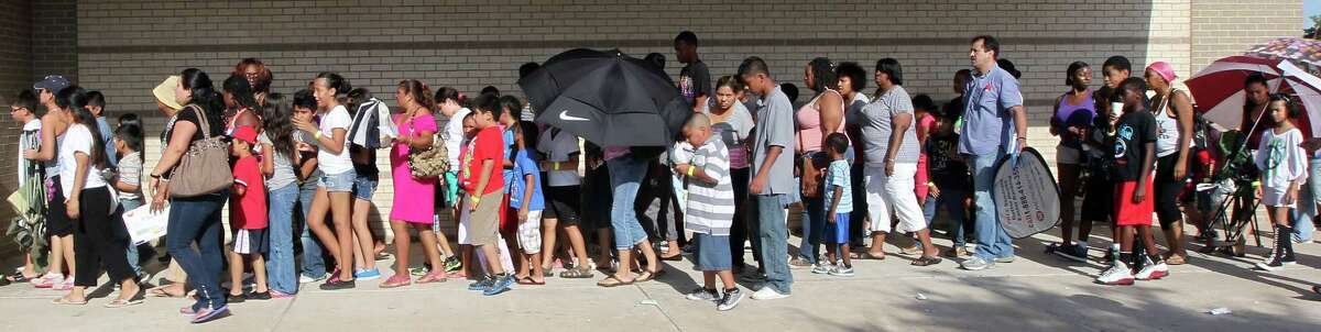 A line forms during the Save Alief Health Fair & Back to School give-away at Alief ISD's Hastings Ninth Grade Center Saturday, Aug. 4, 2012, in Houston. ( James Nielsen / Chronicle )