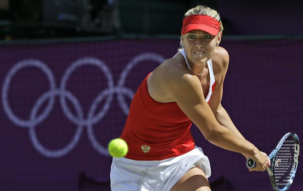 Maria Sharapova of Russia returns a shot to United States' Serena Williams in the women's singles gold medal match at the All England Lawn Tennis Club at Wimbledon, in London, at the 2012 Summer Olympics, Saturday, Aug. 4, 2012. (AP Photo/Victor R. Caivano)