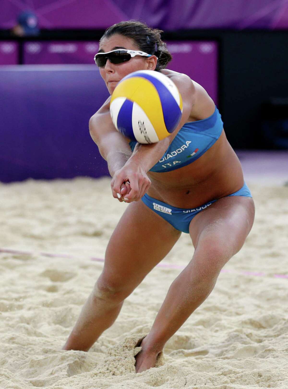 Marta Menegatti of Italy returns the ball during a two set loss to the United States during a beach volleyball match at the 2012 Summer Olympics, Sunday, Aug. 5, 2012, in London. (AP Photo/Dave Martin)