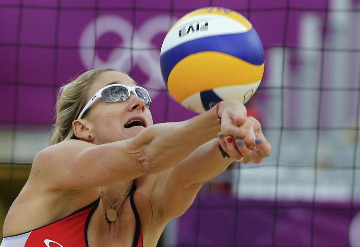 US Kerri Walsch reaches for a ball during the quarterfinal women's beach volleyball match against Italy at the 2012 Summer Olympics, Sunday, Aug. 5, 2012, in London. (AP Photo/Petr David Josek)