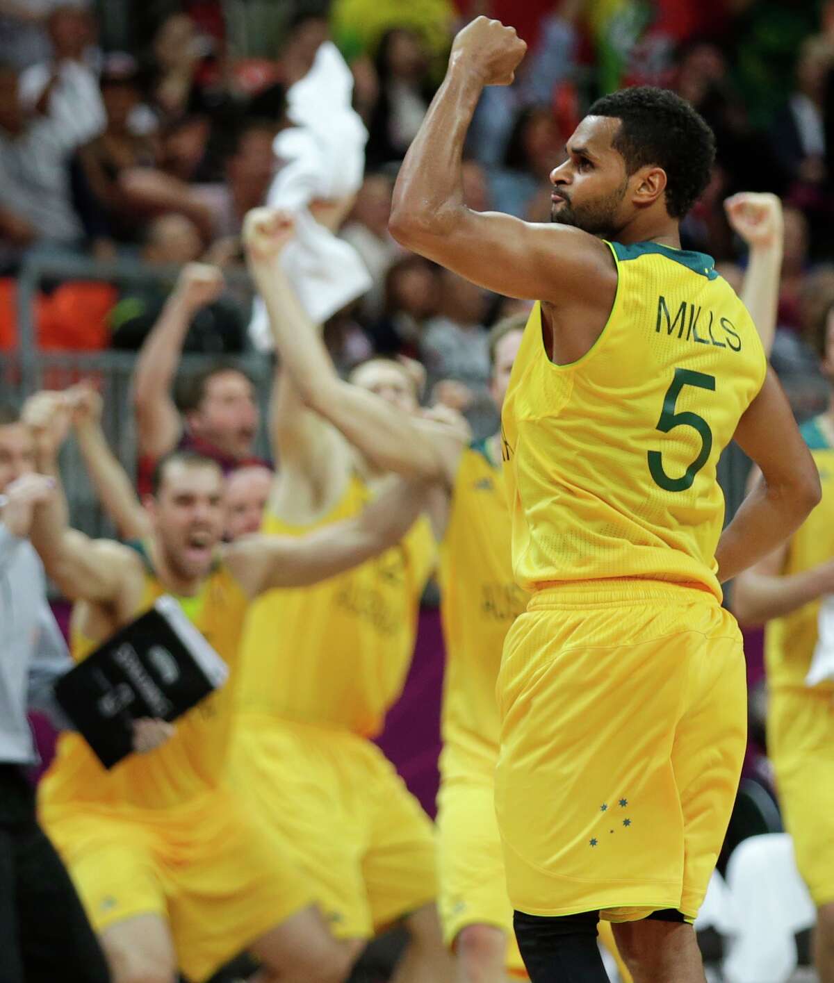 Australia's Patrick Mills pumps his fist after hitting the game-winning 3-point shot to pull ahead of Russia with time expiring during a men's basketball game at the 2012 Summer Olympics, Monday, Aug. 6, 2012, in London.(AP Photo/Charles Krupa)