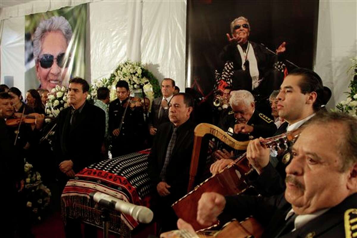 Mariachi musicians perform as city officials stand at honor guard next to the coffin of famed Mexican singer Chavela Vargas during a homage at the traditional Mariachi Garibaldi Plaza in Mexico City, Monday, Aug. 6, 2012. Chavela Vargas, who defied gender stereotypes to become one of the most legendary singers in Mexico, died Aug. 5 at age 93.