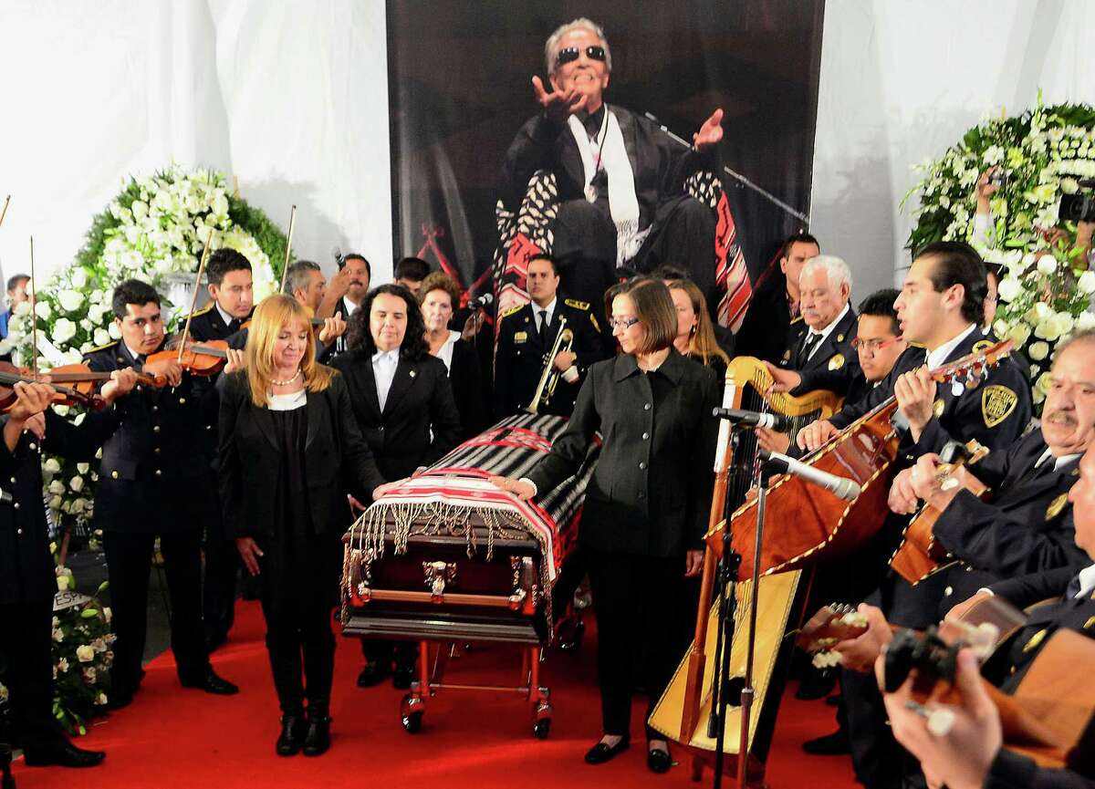 Relatives and musicians stand alongside the coffin of the late Costa Rican-born Mexican singer Chavela Vargas during a ceremony in her honour at Garibaldi Square in Mexico City, on August 6, 2012. The iconic singer, who was known for her mastery of the sad and sultry bolero, died on August 5, 2012 at the age of 93. AFP PHOTO/Alfredo Estrella (Photo credit should read ALFREDO ESTRELLA/AFP/GettyImages)
