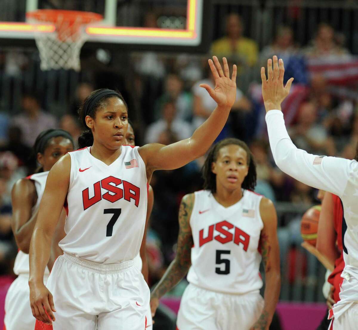 US guard Maya Moore celebrates with team mates after winning the women's quarter final basketball match USA vs Canada at the London 2012 Olympic Games on August 7, 2012 at the North Greenwich arena in London. AFP PHOTO / MARK RALSTONMARK RALSTON/AFP/GettyImages