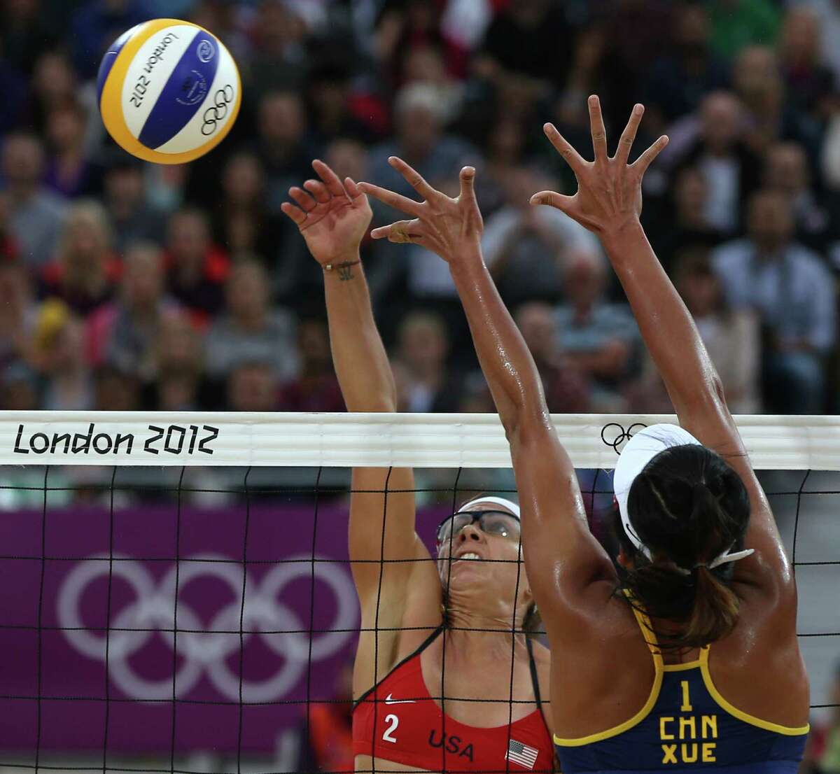 China's Xue Chen, right, tries to block US Misty May-Treanor during their semifinal women's beach volleyball match at the 2012 Summer Olympics, Tuesday, Aug. 7, 2012, in London. (AP Photo/Petr David Josek)