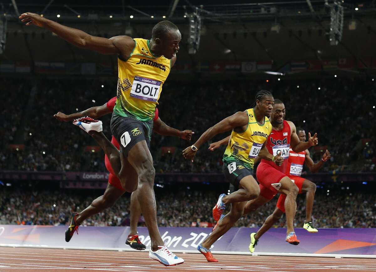 Jamaica's Usain Bolt, foreground left, goes to cross the finish line ahead of Jamaica's Yohan Blake, third from right, United States' Tyson Gay, second from right, and Trinidad's Richard Thompson in the men's 100-meters final during the athletics in the Olympic Stadium at the 2012 Summer Olympics, London, Sunday, Aug. 5, 2012. (Matt Dunham / Associated Press)