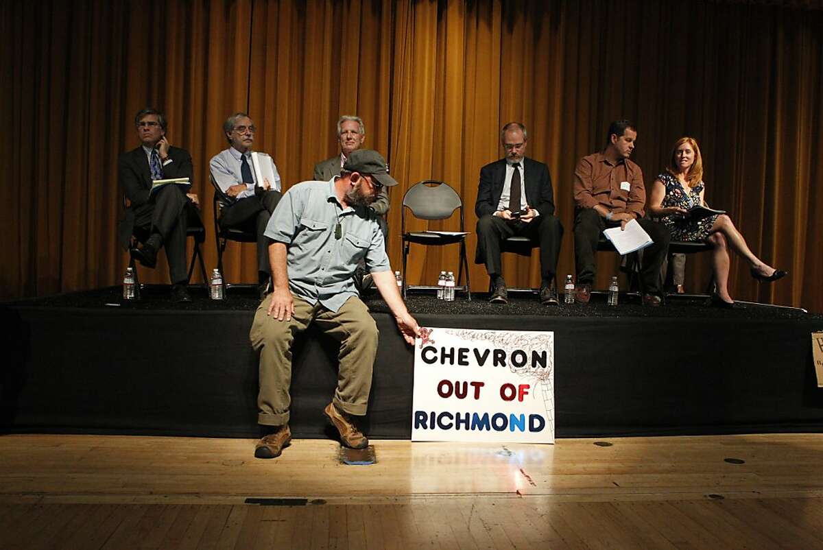 No Name, a protester with Occupy tries to disrupt the Town Hall meeting among the members of the Richmond community as they talk to representatives of Chevron, Tuesday Aug. 7, 2012, in Richmond, Calif.