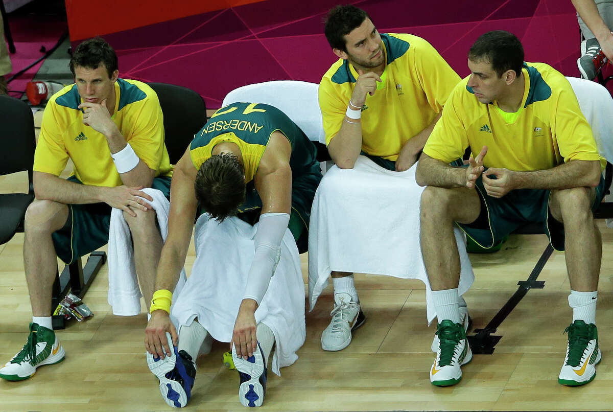 Australia's players sit on the bench during the final moments of their quarterfinal men's basketball game against United States at the 2012 Summer Olympics, Wednesday, Aug. 8, 2012, in London. (AP Photo/Victor R. Caivano)
