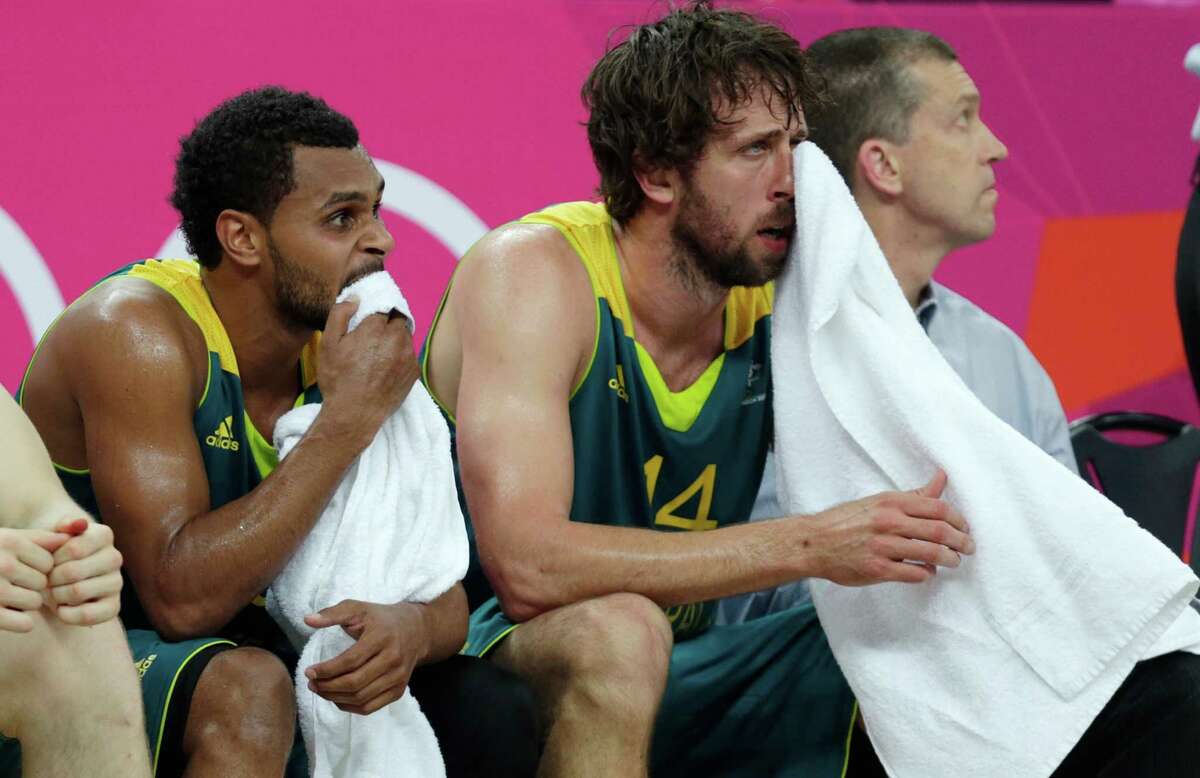Australia's Patrick Mills, left, and Matt Nielsen sit on the bench during the final minutes of a game against the United States during a men's quarterfinals basketball game at the 2012 Summer Olympics, Thursday, Aug. 9, 2012, in London. (AP Photo/Charles Krupa)