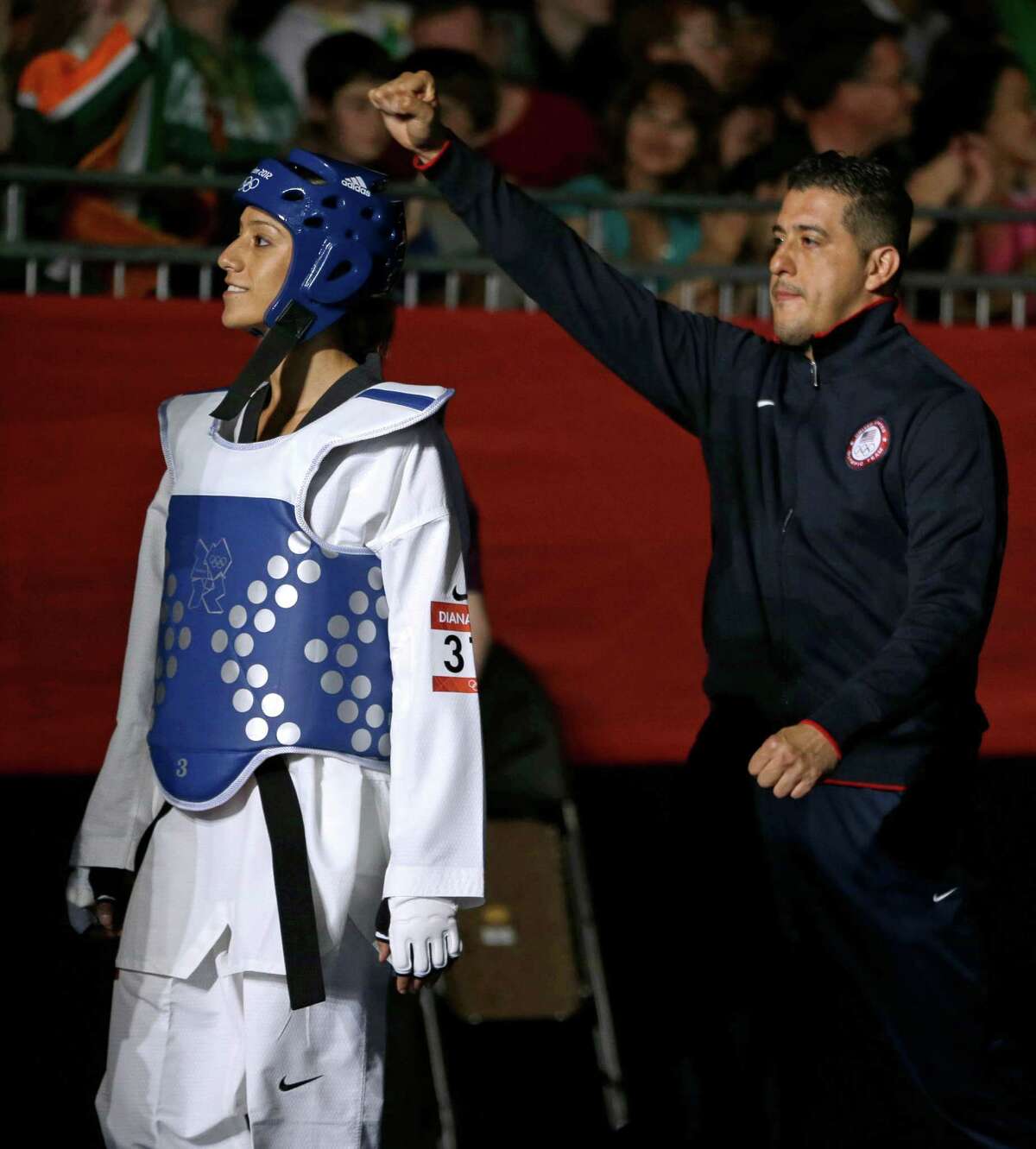 United States' Diana Lopez makes her way to fight China's Hou Yuzhuo in women's 57-kg taekwondo competition at the 2012 Summer Olympics, Thursday, Aug. 9, 2012, in London.