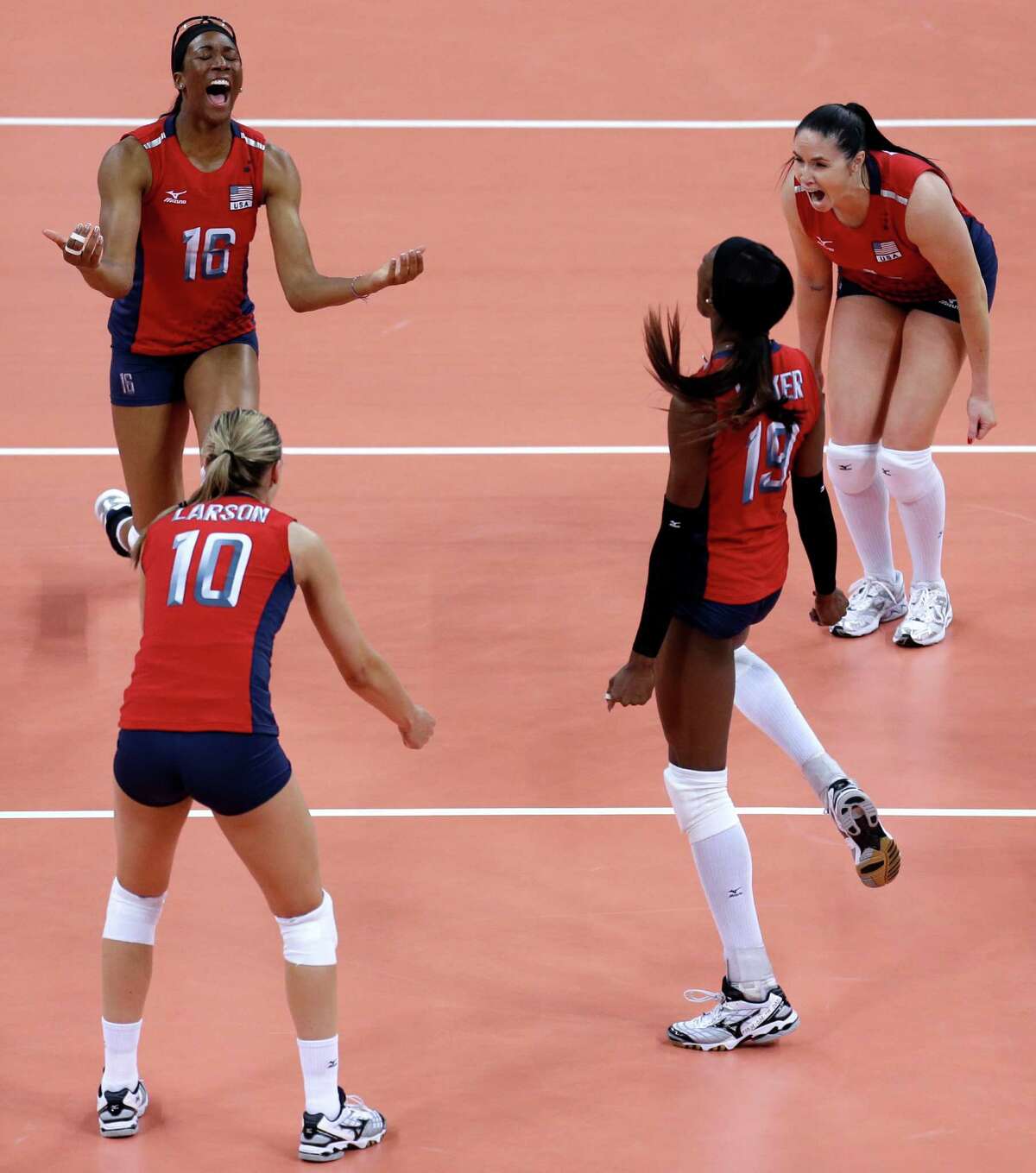 Members of team United States, clockwise from top left, Foluke Akinradewo, Lindsey Berg, Destinee Hooker and Jordan Larson celebrate after defeating South Korea in a women's semifinal volleyball match at the 2012 Summer Olympics, Thursday, Aug. 9, 2012, in London. (AP Photo/Jeff Roberson)