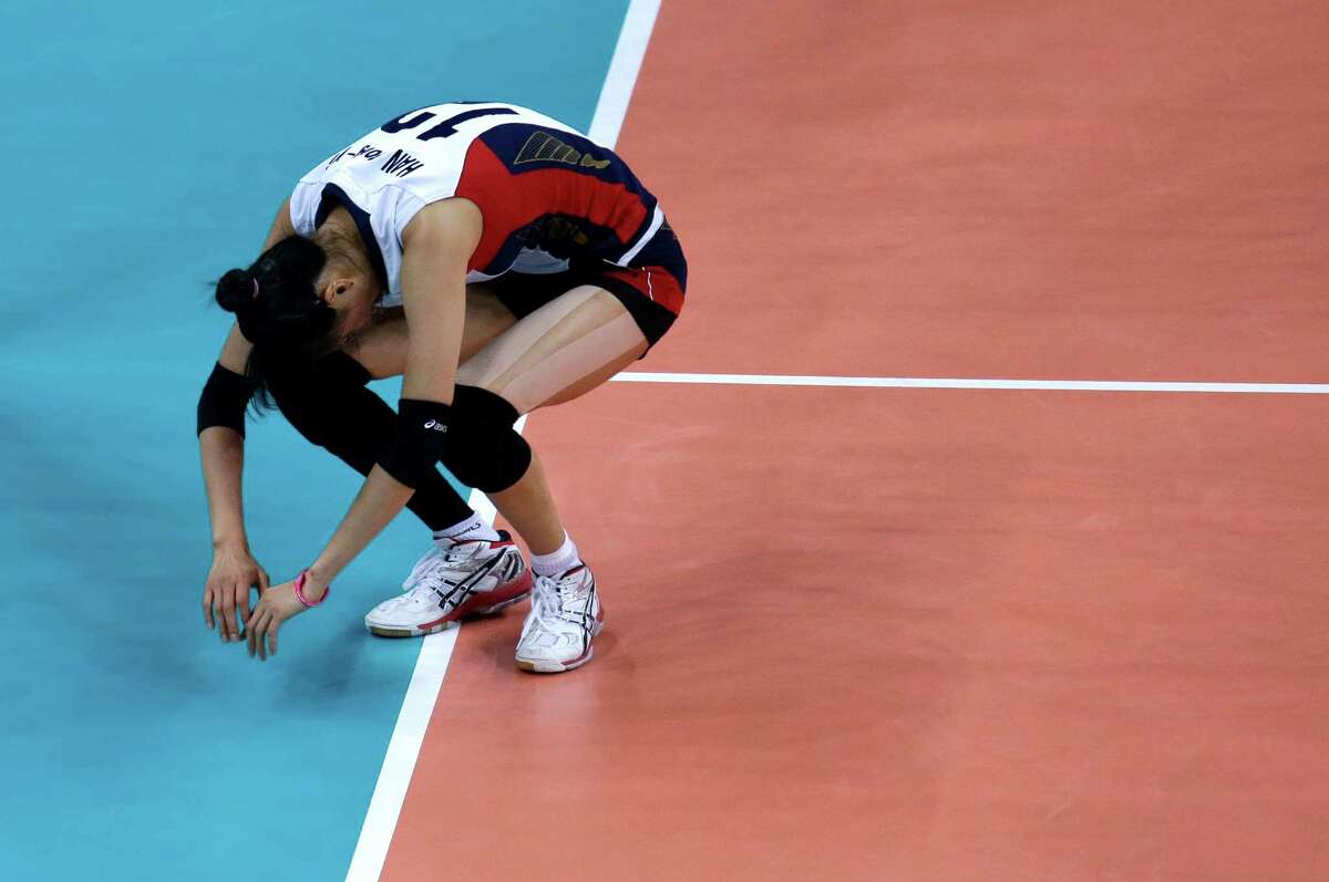 South Korea's Han Song-yi reacts after a point was scored by the United States during a women's semifinal volleyball match at the 2012 Summer Olympics, Thursday, Aug. 9, 2012, in London. (AP Photo/Jeff Roberson)