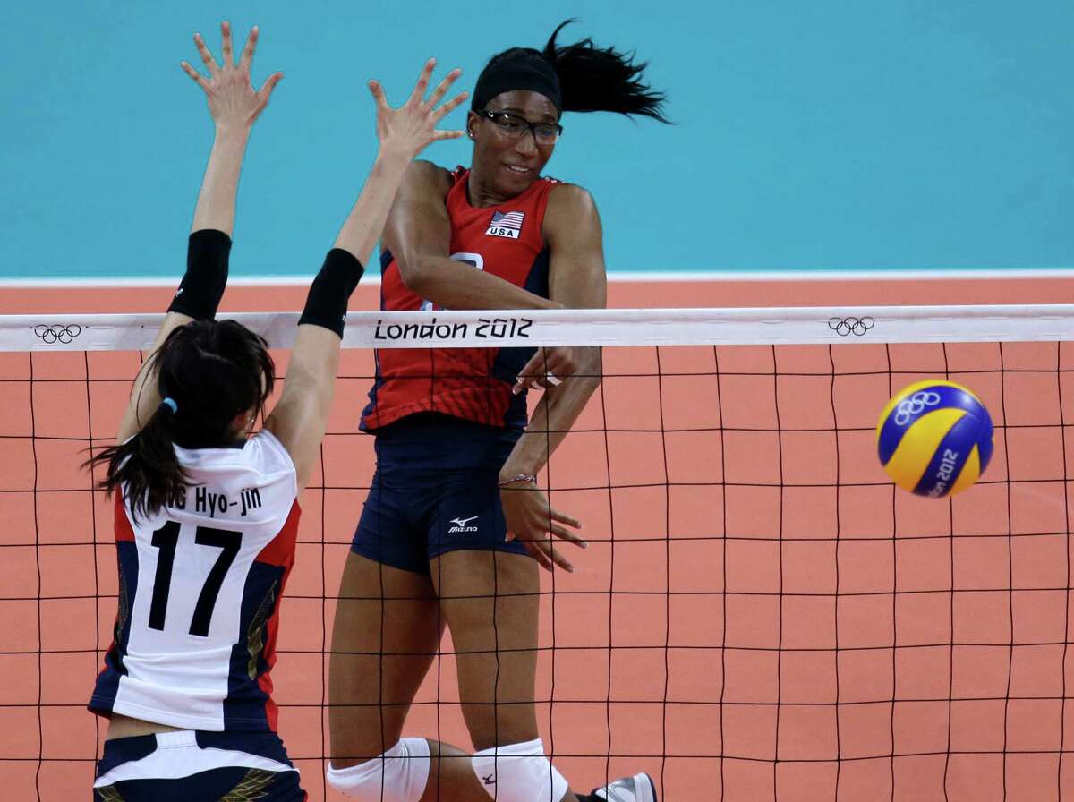 United States' Foluke Akinradewo, right, spikes the ball away from South Korea's Yang Hyo-jin during a women's semifinal volleyball match at the 2012 Summer Olympics, Thursday, Aug. 9, 2012, in London. (AP Photo/Jeff Roberson)