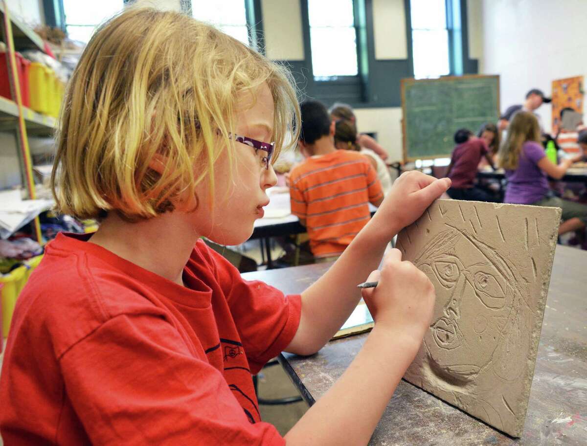 Seven-year-old Madeline Epping of East Greenbush works on a self portrait relief carving at summer arts camp at the Arts Center of the Capital Region in Troy Wednesday July 25, 2012. (John Carl D'Annibale / Times Union)