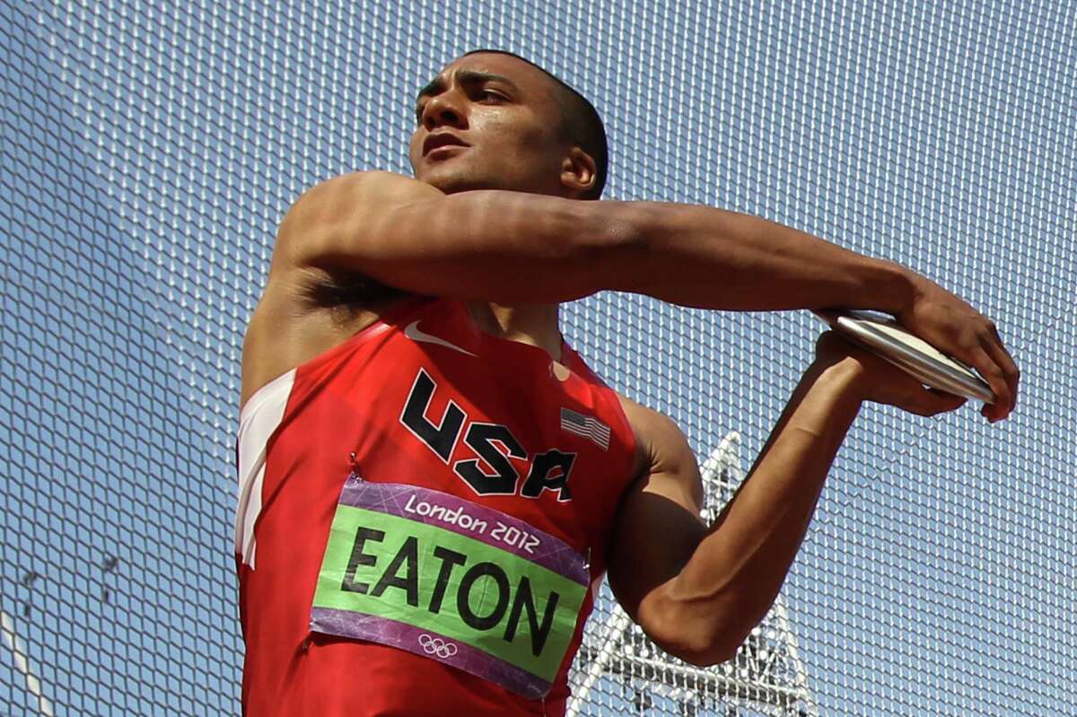 US' Ashton Eaton competes in the men's decathlon discus throw at the athletics event during the London 2012 Olympic Games on August 9, 2012 in London. AFP PHOTO / ADRIAN DENNISADRIAN DENNIS/AFP/GettyImages