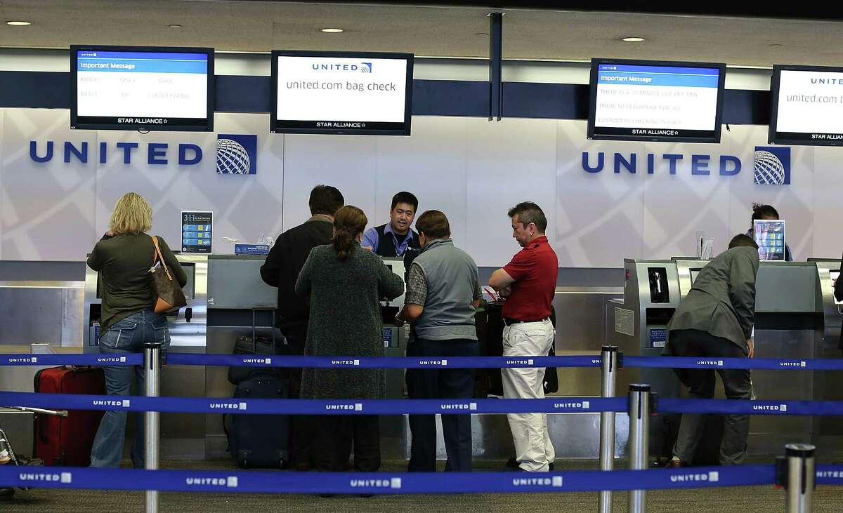 United passengers check in at San Francisco International Airport in July. The airline says "we are taking immediate action" to deal with performance issues.