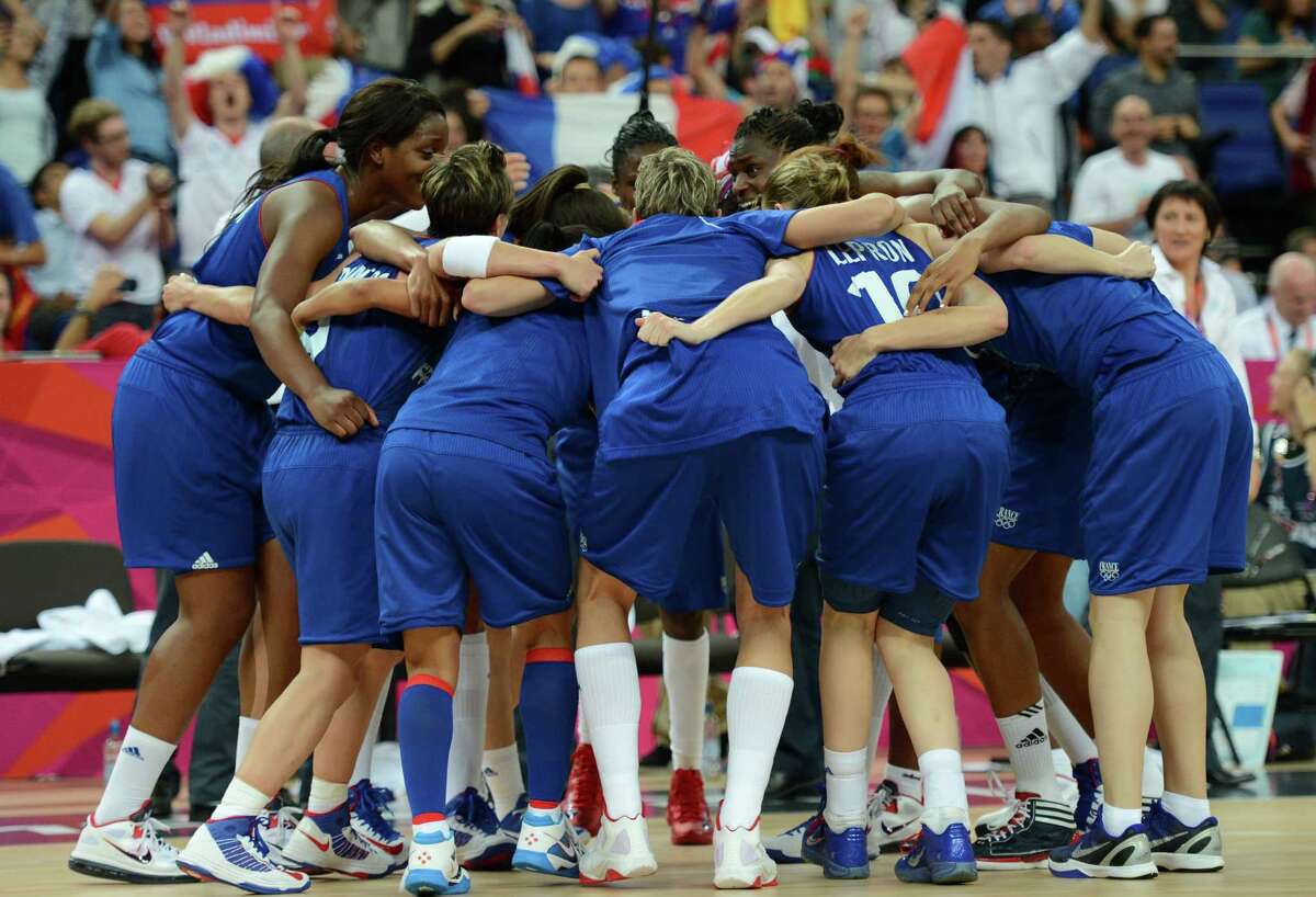 French players celebrate after winning 81-64 against Russia in the London 2012 Olympic Games women's semifinal basketball game bewteen Russia and France at the North Greenwich Arena in London on August 9, 2012. AFP PHOTO/TIMOTHY A. CLARYTIMOTHY A. CLARY/AFP/GettyImages