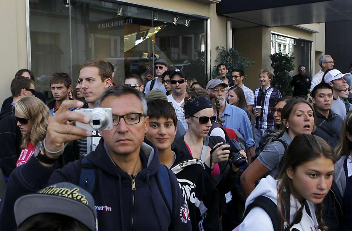 A crowd of onlookers watch a production crew film Woody Allen's new feature-length movie at Shreve and Co. jewelers at Post Street and Grant Avenue in San Francisco, Calif. on Friday, Aug. 10, 2012.