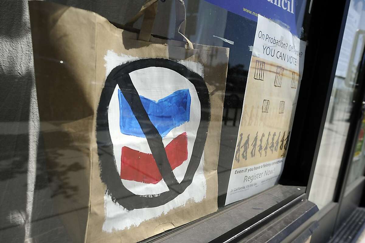 An anti-Chervon sign is seen in a window ove a shop on MacDonald Ave. in Richmond, CA on Friday August 10th, 2012