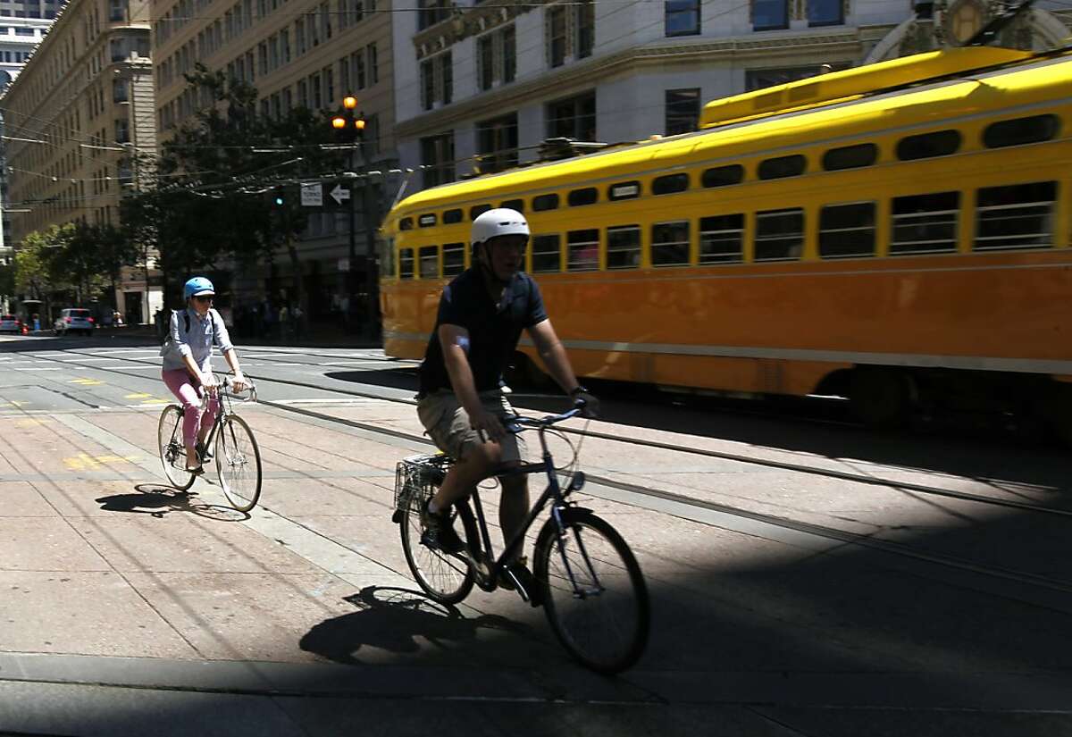 Bicyclists pedal west on Market Street in San Francisco, Calif. on Friday, Aug. 10, 2012.