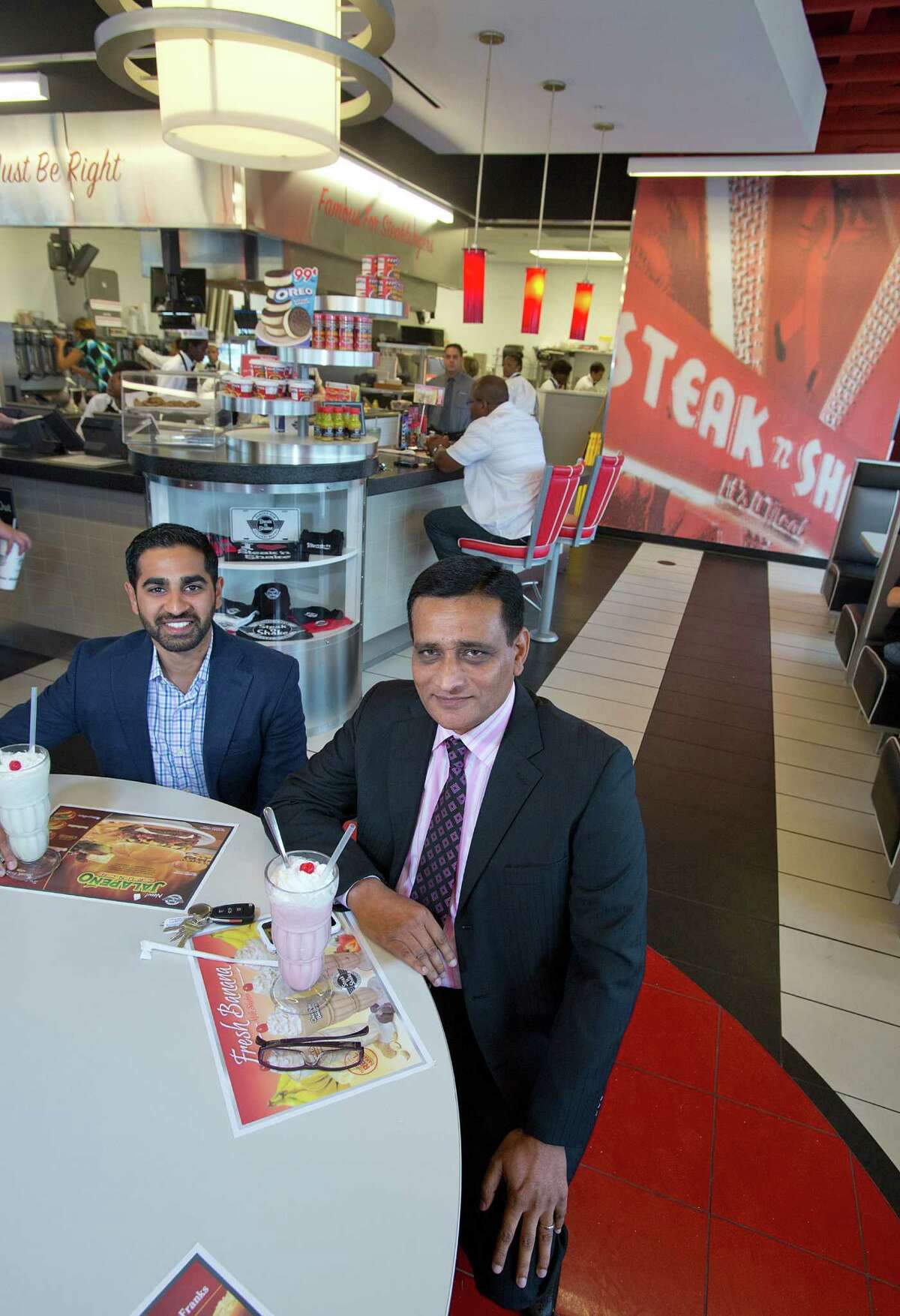 7/12/12: Anil Mohammed ( in blue) Vice President of SNS Franchise Ventures with Moez Dhuka ( in black) President of SNS Ventures at the Shake n Steak store in Pearland, Texas. For the Chronicle: Thomas B. Shea