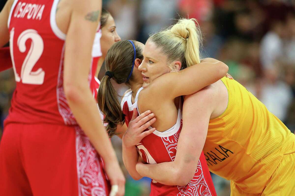 LONDON, ENGLAND - AUGUST 11: Lauren Jackson #15 of Australia hugs Becky Hammon #9 of Russia after Australia won 83-74 during the Women's Basketball Bronze Medal game on Day 15 of the London 2012 Olympic Games at North Greenwich Arena on August 11, 2012 in London, England.