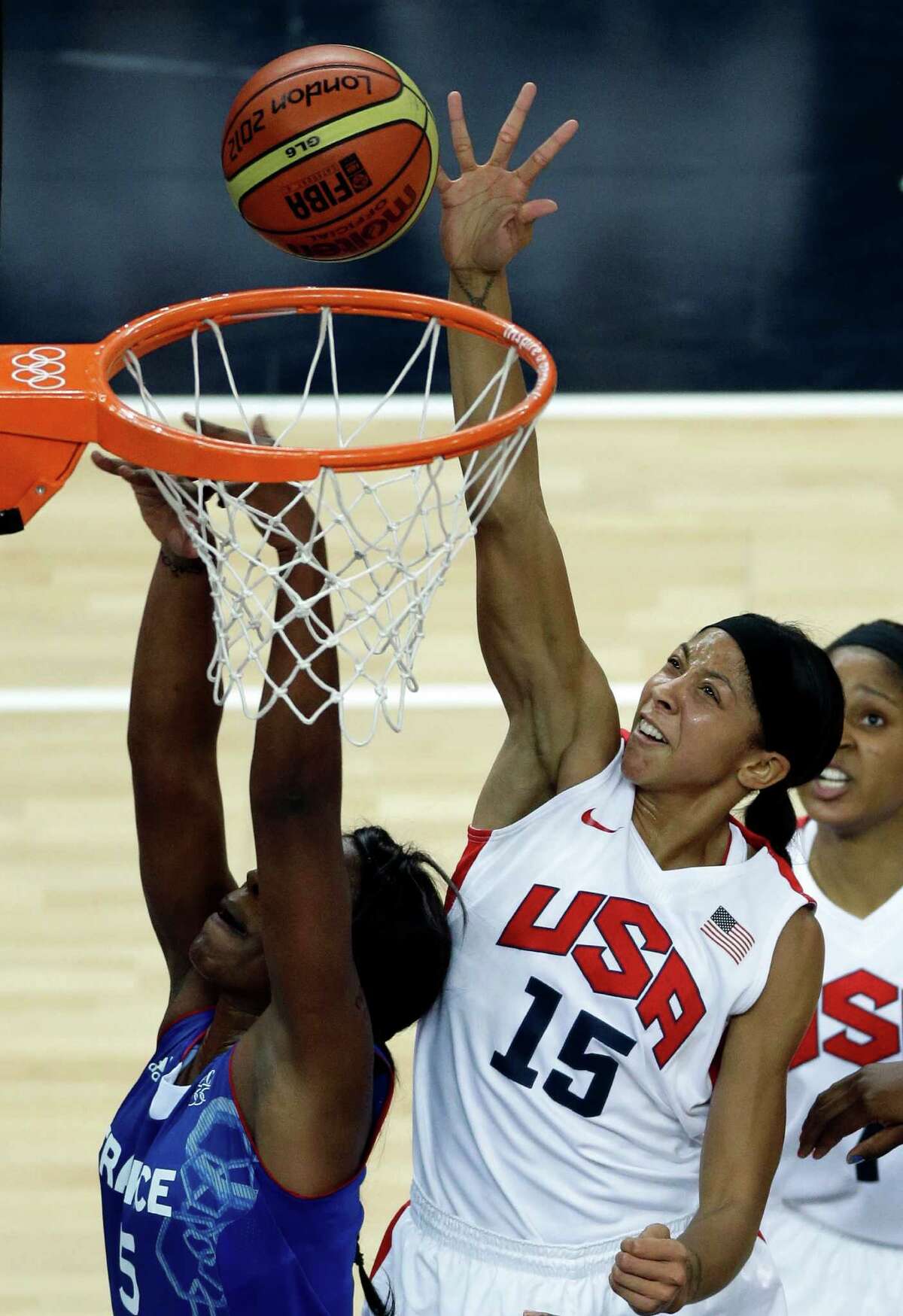 United States' Candace Parker (15) shoots for the basket past France's Endene Miyem during a women's gold medal basketball game at the 2012 Summer Olympics, Saturday, Aug. 11, 2012, in London. (AP Photo/Victor R. Caivano)