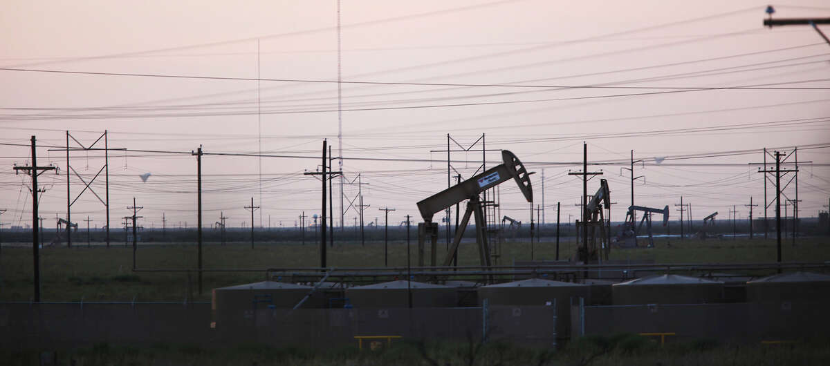 Power lines and pump jacks dot the horizon in the Permian Basin just west of Midland, Texas, Tuesday, July 24, 2012. There are around 150,000 wells in the play that extends hundreds of miles of West Texas from Mentone east to El Dorado. Production in the play is approaching a million barrels a day and along with gas, it represents $2.5 to $3 billion a month in production revenues.
