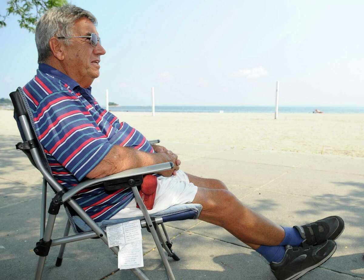 Louis Giancotti, 83, talks about Tuesday's primary election while relaxing at Cummings Beach in Stamford on Thursday, August 9, 2012.