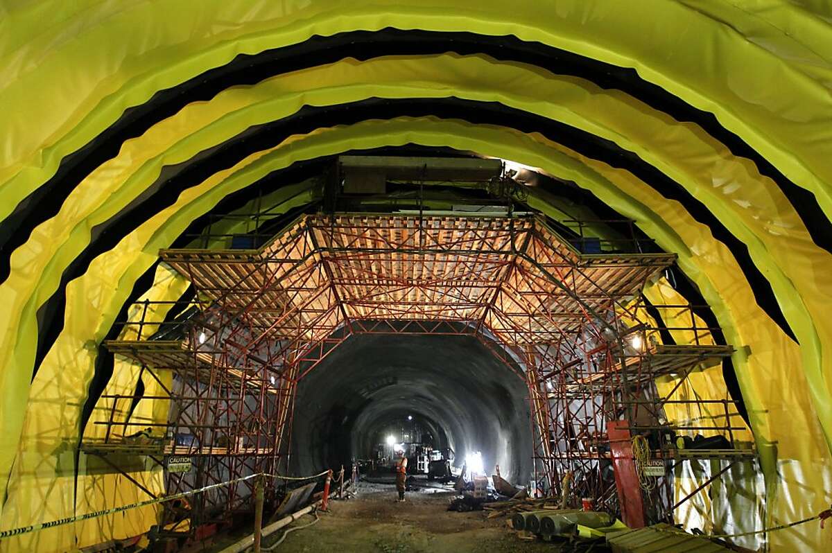 Large strips of waterproof material are attached to the curved wall inside the fourth bore of the Caldecott Tunnel before a mesh of rebar and a thick layer of concrete is poured in Oakland, Calif. on Thursday, Aug. 9, 2012.