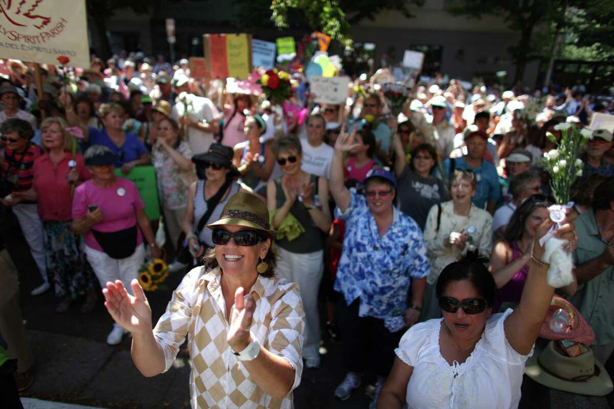 People gather on the steps of Saint James Cathedral in Seattle on Sunday, August 12, 2012. Hundreds of people came out to support Catholic nuns on the steps of Saint James Cathedral, the episcopal seat of Archbishop Peter J. Sartain, the Roman Catholic bishop tasked by the Vatican to oversee nuns in the U.S.