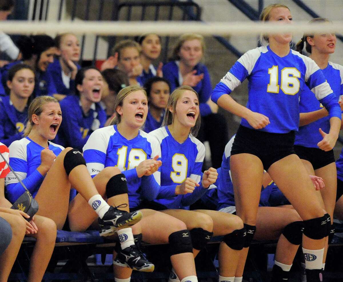 The Alamo Heights bench celebrates a point during a high school volleyball game against Antonian, Monday, Aug. 13, 2012, at Alamo Heights High School in San Antonio.