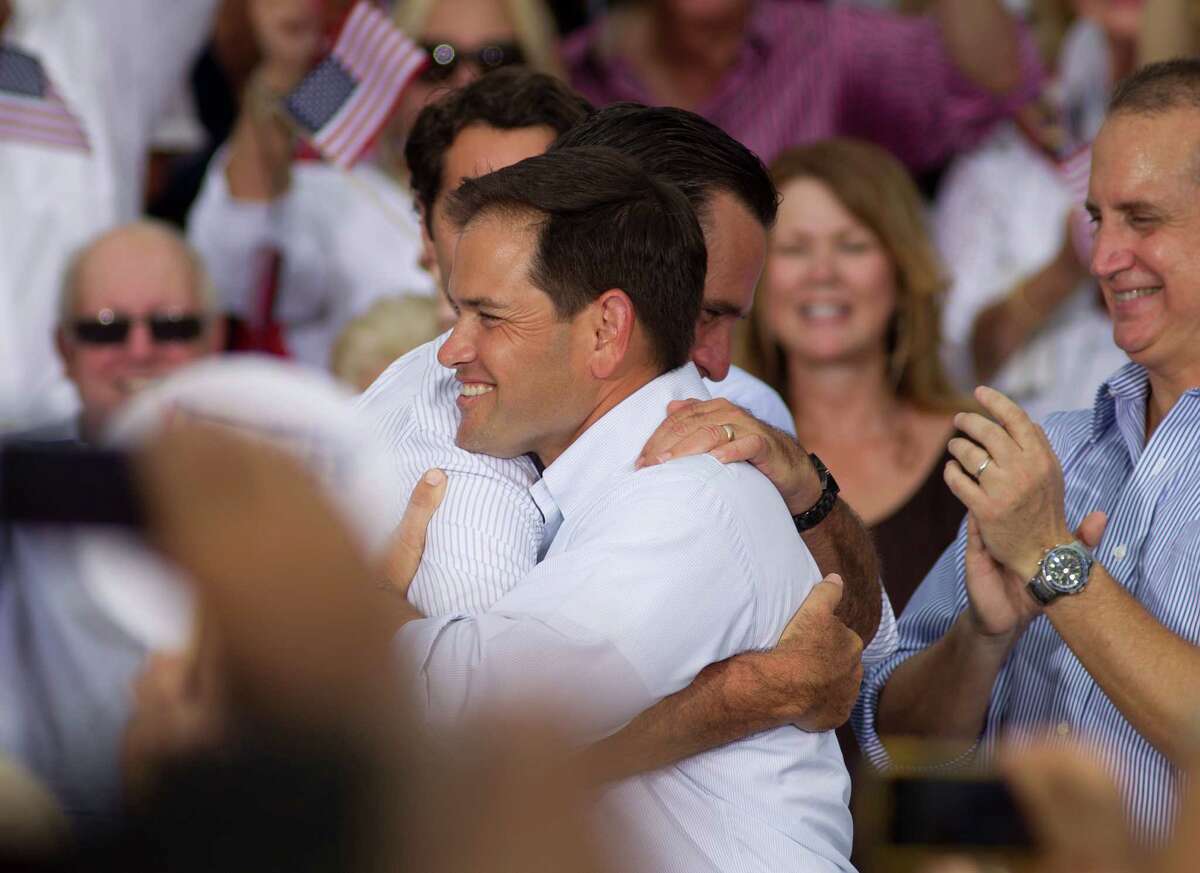 U.S. Rep. Marco Rubio (R-Fla.) hugs Mitt Romney during a campaign stop in Miami, Monday, Aug. 13, 2012. (AP Photo/J Pat Carter)