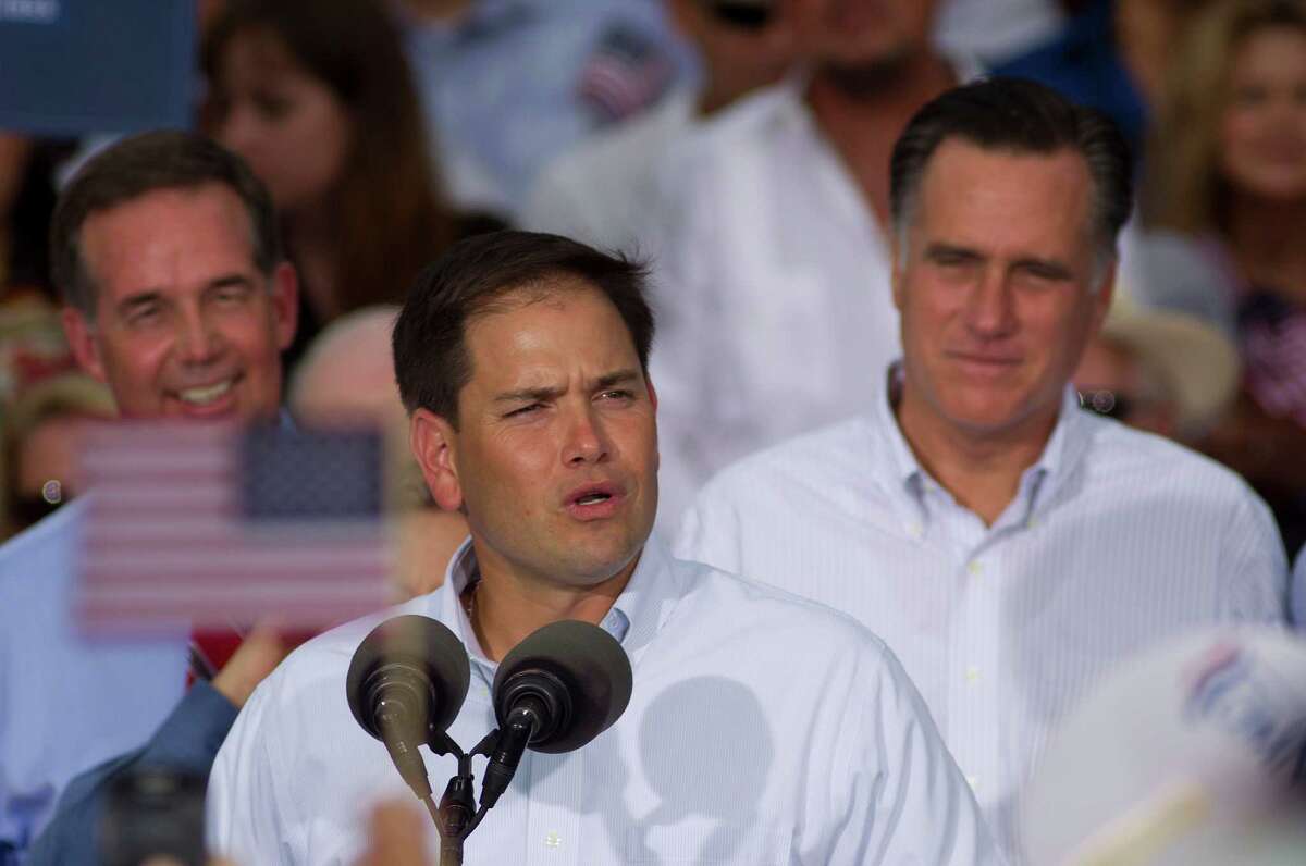 U.S. Rep. Marco Rubio (R-Fla.) introduces Mitt Romney, back right, during a campaign stop in Miami, Monday, Aug. 13, 2012. (AP Photo/J Pat Carter)