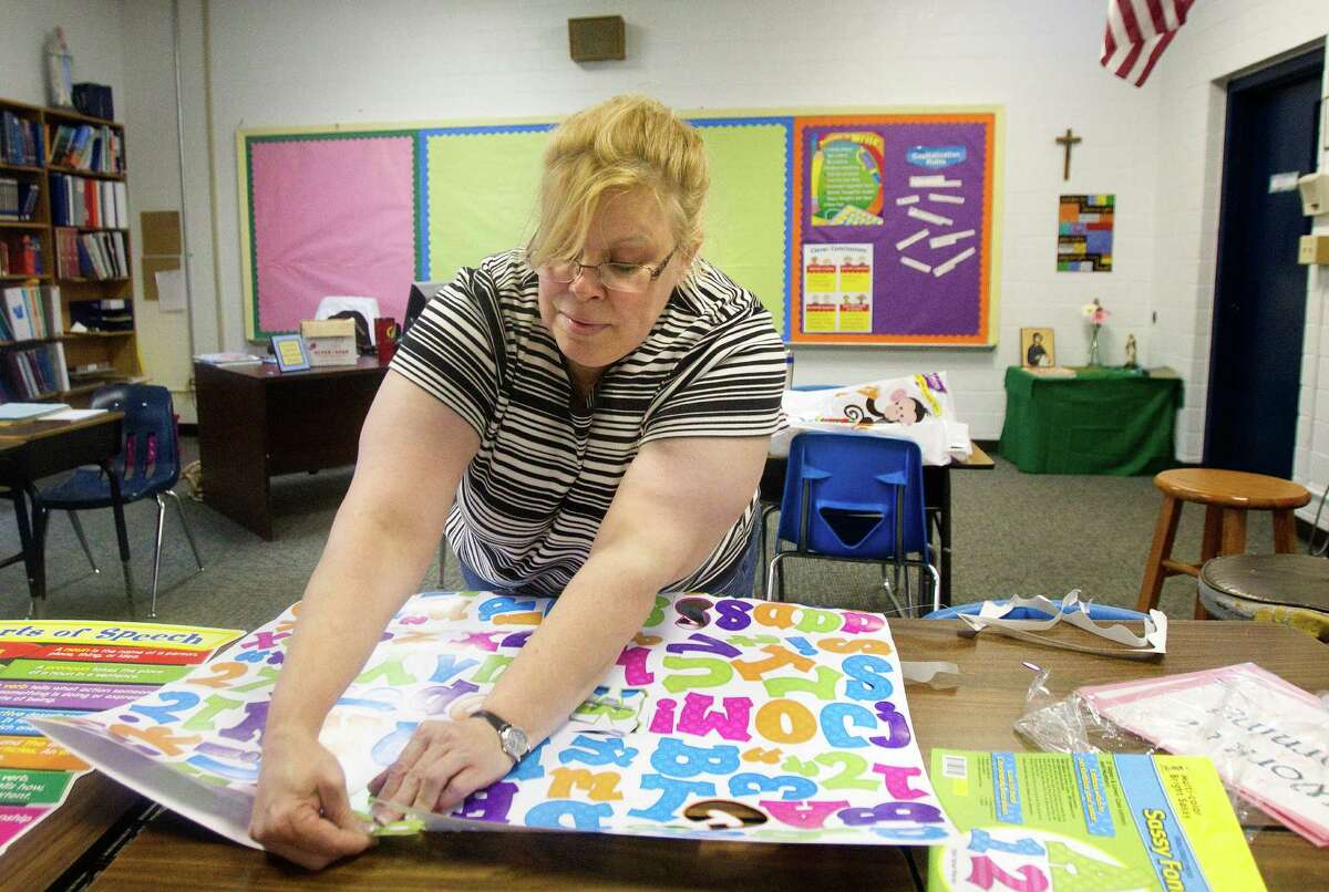 Allison Cogburn gets her classroom ready at Corpus Christi Catholic School in Houston. It has 215 students.
