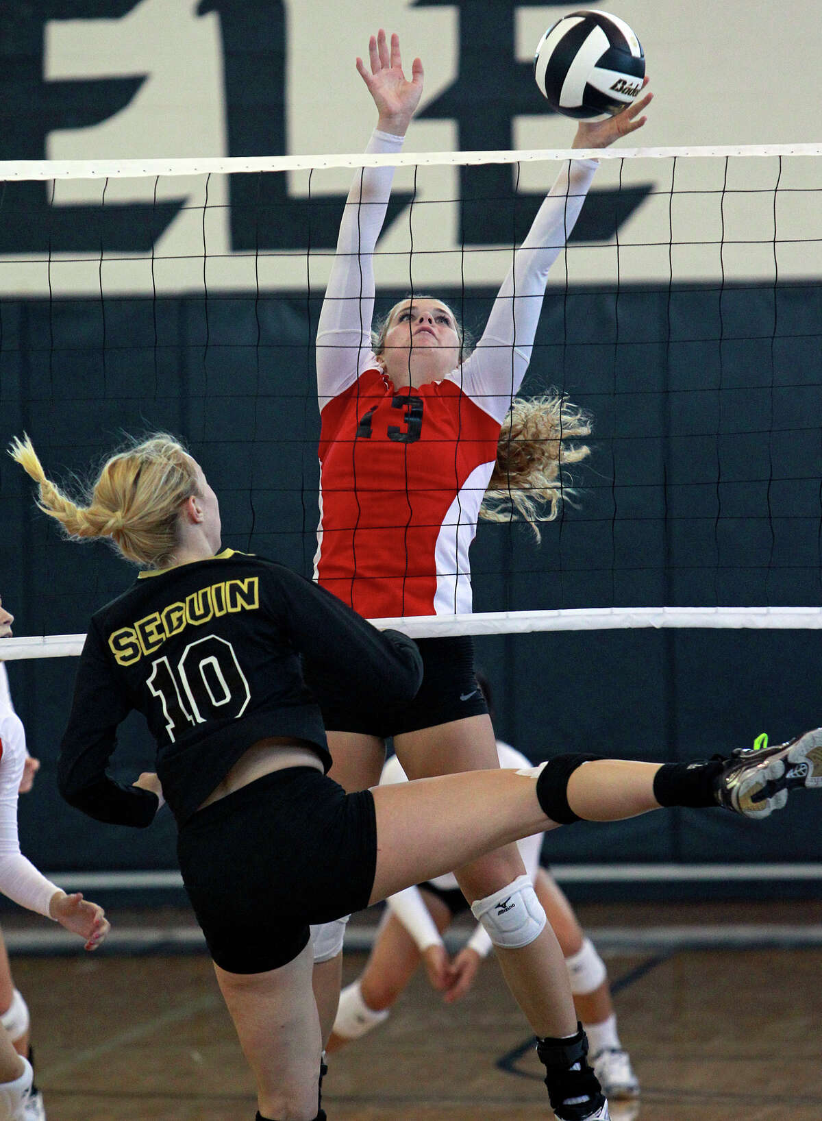 Katie Cavanaugh (13) stops a shot by Erin Moore as New Braunfels Canyon beats Seguin 3-0 at Steele High School gym on Tuesday, Aug. 14, 2012.