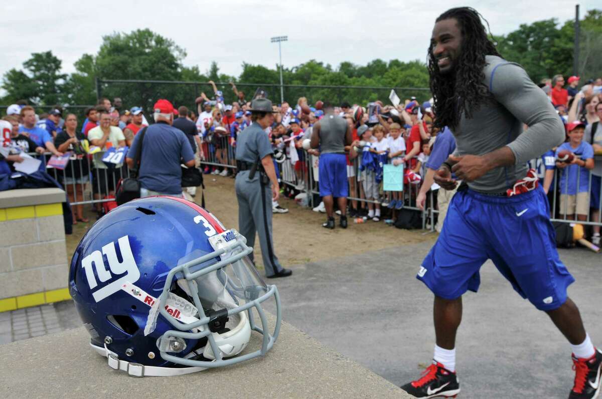 New York Giants wide receiver Isaiah Stanback runs off the field at the end of practice on the last day of training camp at UAlbany on Tuesday Aug. 14, 2012 in Albany, NY. Running back Joe Martinek's helmet is at left, while he signs autographs. (Philip Kamrass / Times Union)