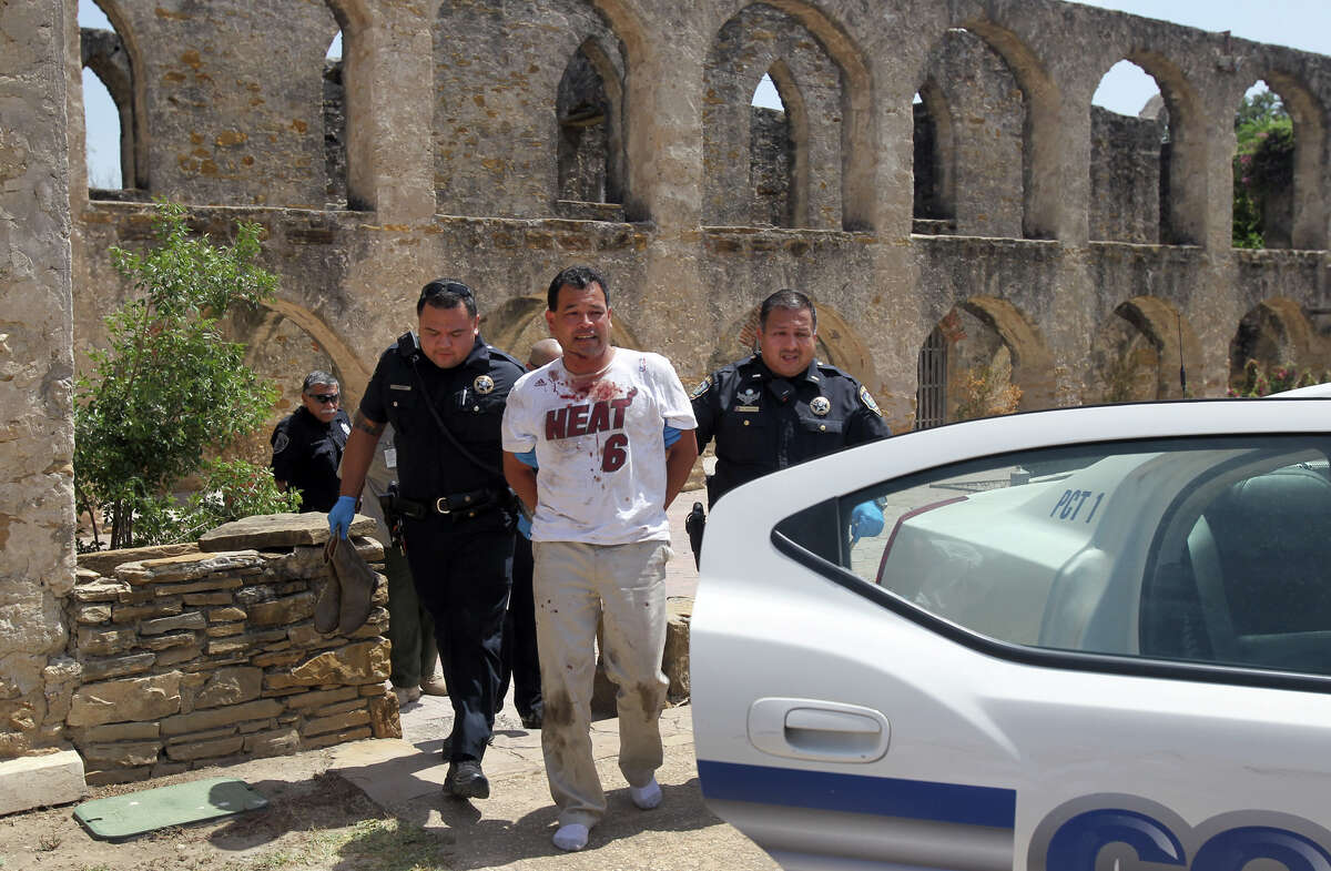 Deputies with the Bexar County Constable's Office, Precinct 1, escort a man (wearing Heat shirt) from the church building at Mission San Jose Wednesday August 15, 2012 after disturbing visitors and acting belligerent. Law officials were called to the scene after mission officials received reports of a man yelling in the church and acting in a disorderly manner. The man was taken to a hospital and officials did not immediately know if the man was intoxicated or suffering from a mental disorder.