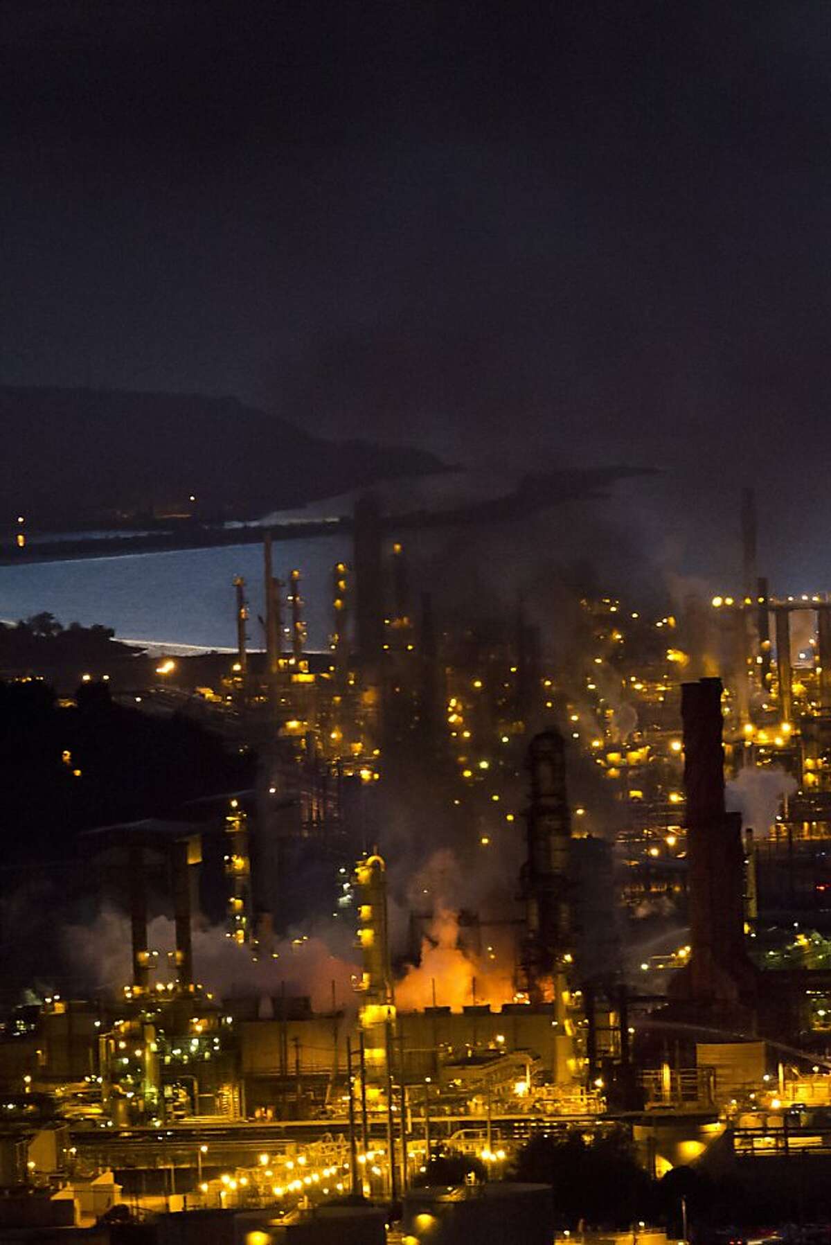 Smoke bellows from a fire at the Chevron refinery following an explosion at 6:30 on Monday, August 6, 2012 in Richmond, Calif.