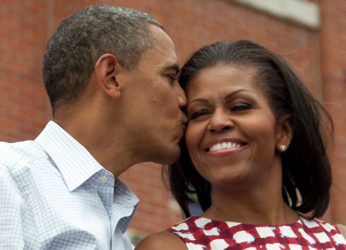 President Barack Obama kisses first lady Michelle Obama at a campaign event in Dubuque, Iowa.