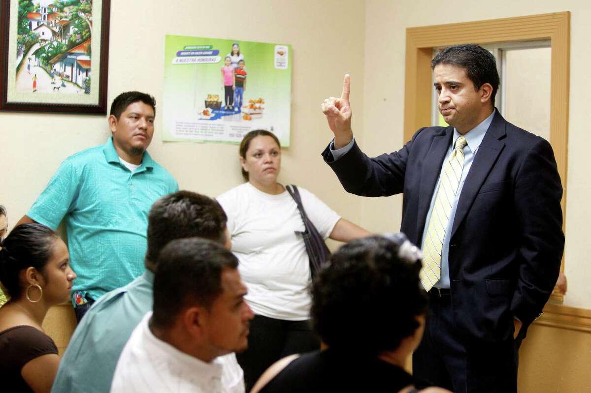 Attorney Alvino Guajardo warns people waiting for paperwork at the Honduran Consulate of scams and urges parents to find a legal source they can trust. ﻿