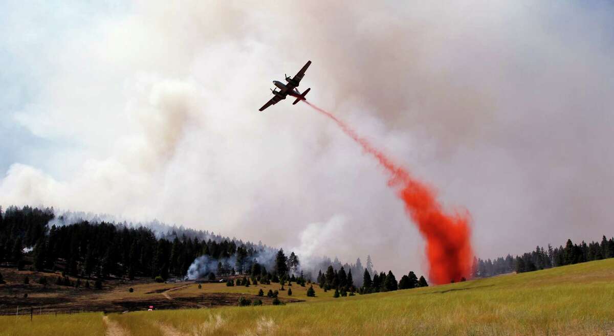 Crews battle dozens of wildfires