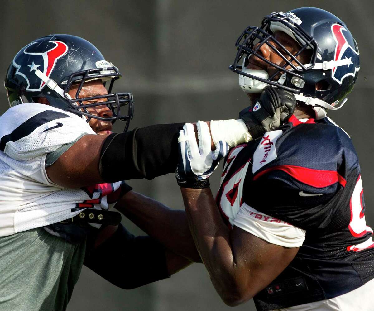 In a battle of Smiths on Wednesday, guard Wade Smith, left, goes one-on-one against defensive end Antonio Smith. The Texans had a brisk morning practice on coach Gary Kubiak's 51st birthday.