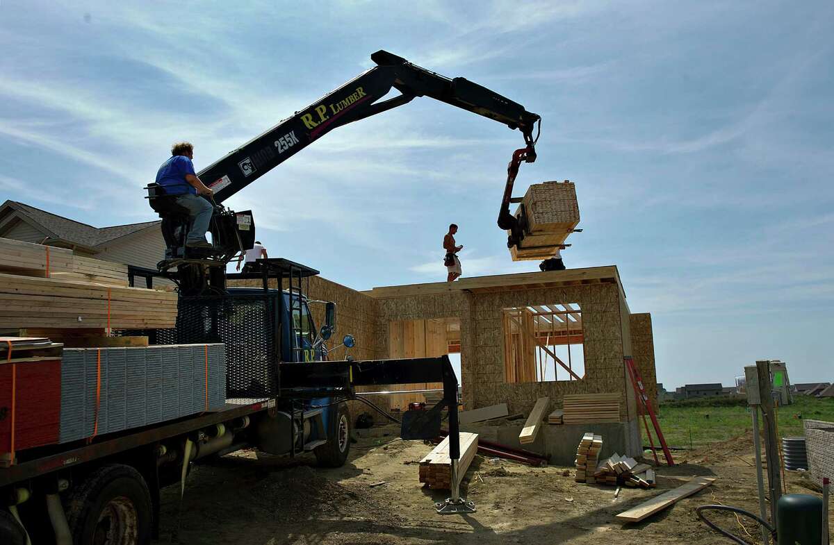 Lumber is delivered to a home being built in Peoria, Ill. Home builder confidence rose in August to a five-year high, according to an industry index.
