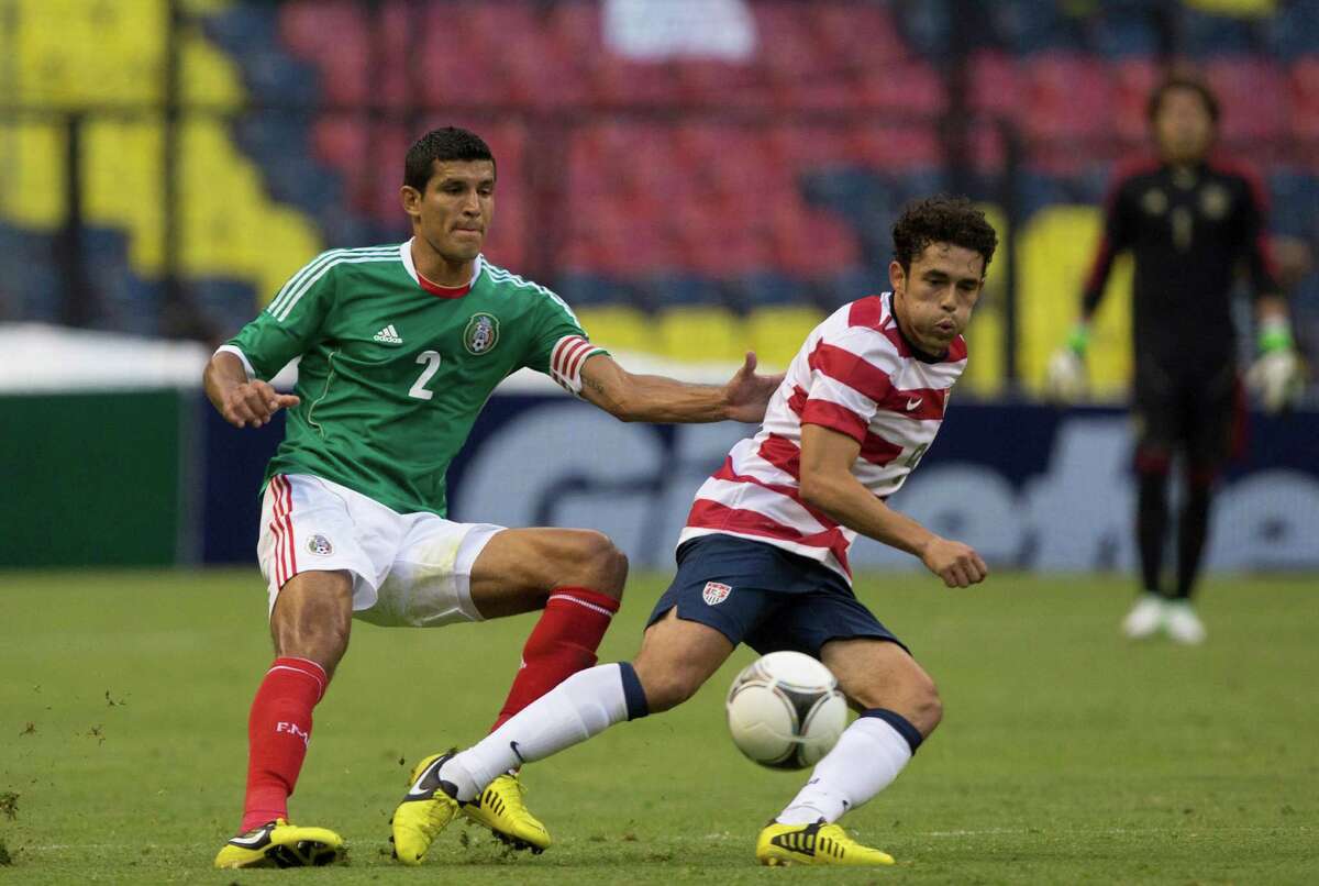 MEXICO CITY, MEXICO - AUGUST 15: Javier Rodriguez of Mexico fights for the ball with Herculez Gomez of the United States during a FIFA friendly match between Mexico and US at Azteca Stadium on August 15, 2012 in Mexico City, Mexico.