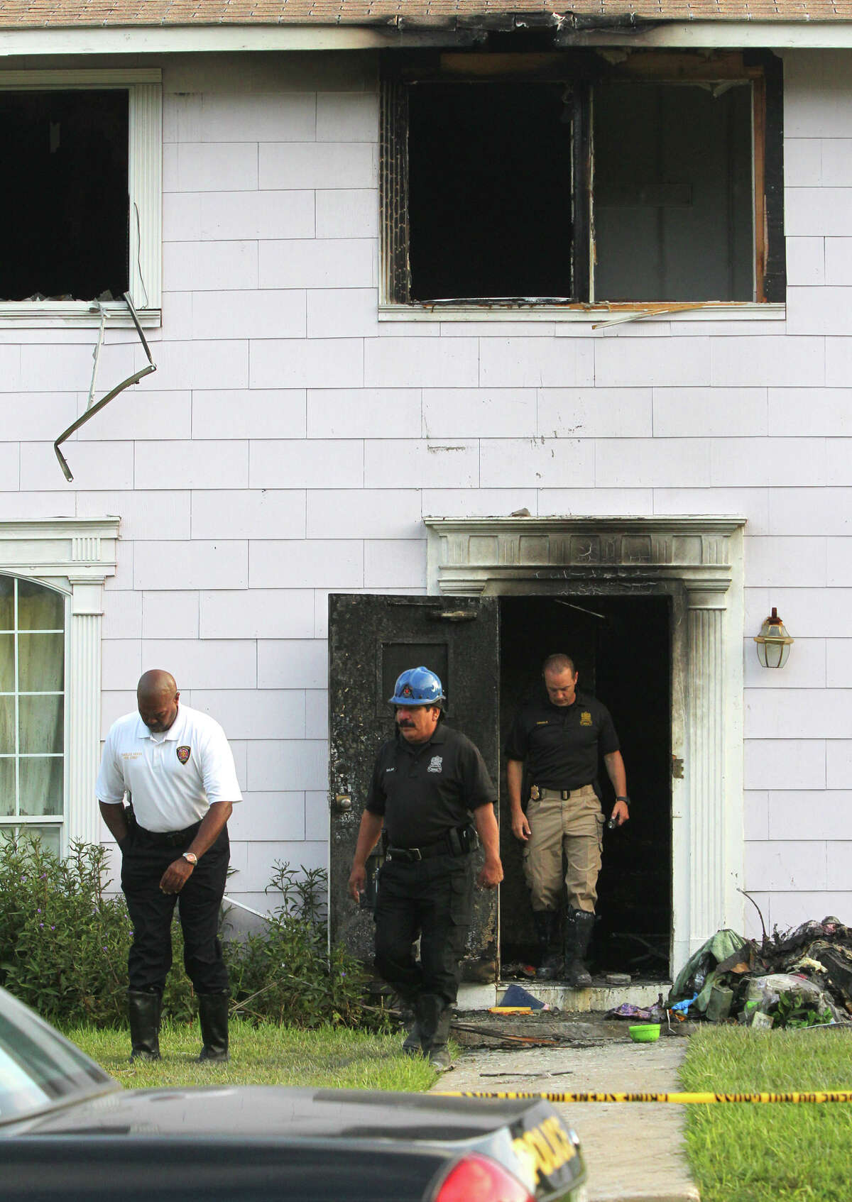 San Antonio Fire Department Chief Charles Hood (left) exits a building on the 300 block of West Norwood in North Central San Antonio where a fatal fire broke out Wednesday night.