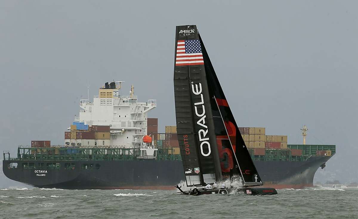 Shipping traffic as the Oracle Team USA America's Cup 45 number 5 boat, on Wednesday August 15, 2012, in San Francisco, Calif., as the team practices on San Francisco Bay in preparation for the 2012 America's Cup World Series races, August 21-26 2012.