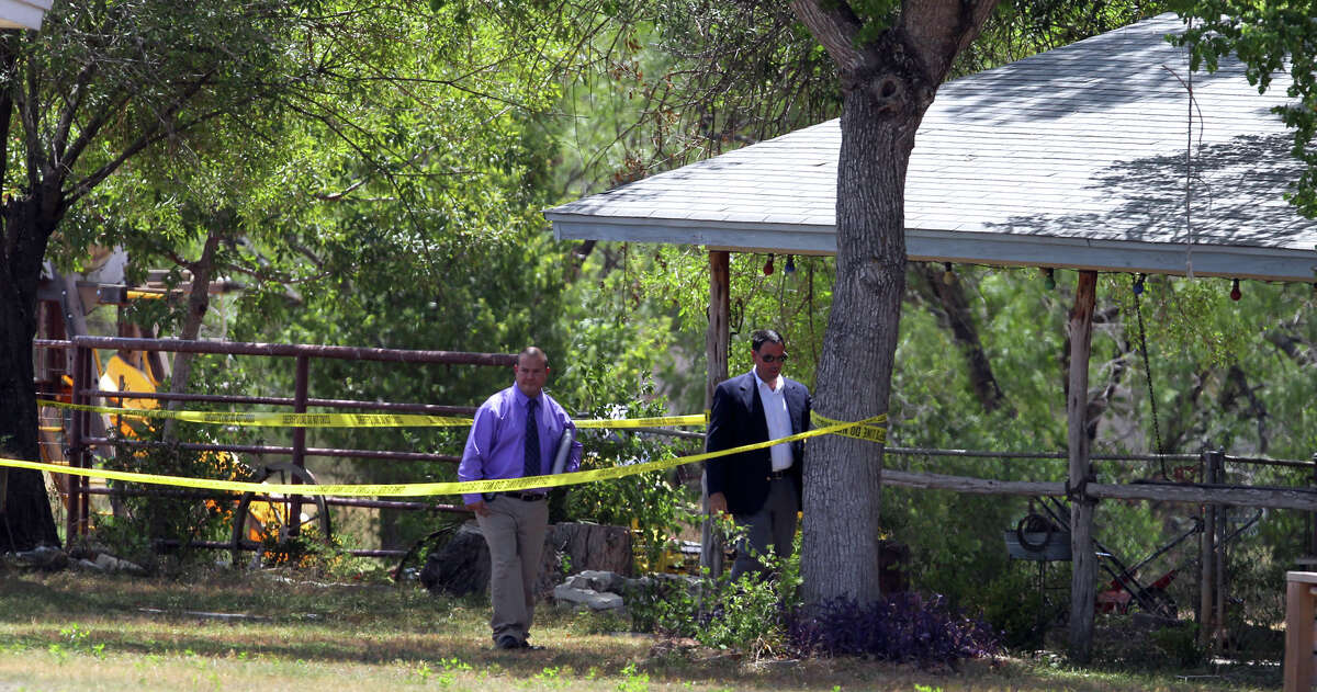 Investigators walk at a property near the 4300 block of Stuart Road in East Bexar County after a shooting took place on August 16, 2012. According to Bexar County Sheriff's Office Public Information Officer Louis Antu, a 14-year-old boy shot his 12-year-year old brother with a .22 caliber weapon at the location.